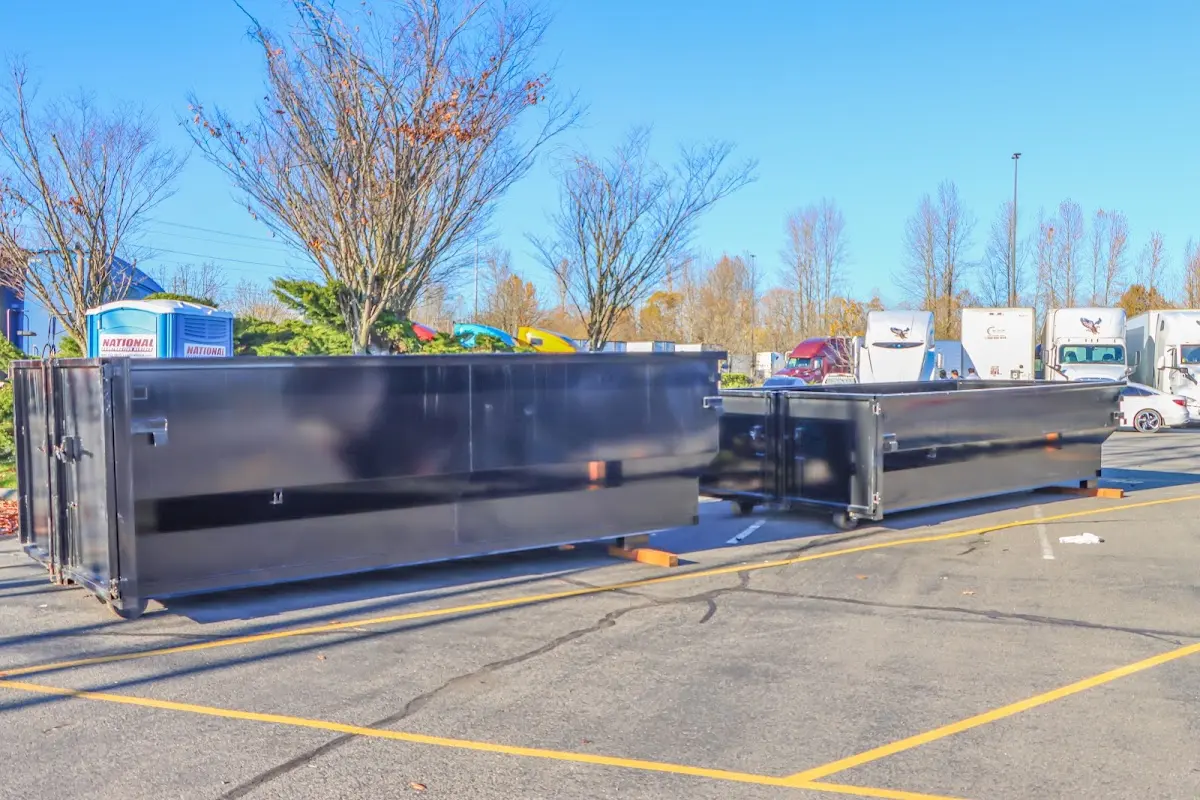 Professional dumpster rental service with roll-off container on residential driveway in Waukee